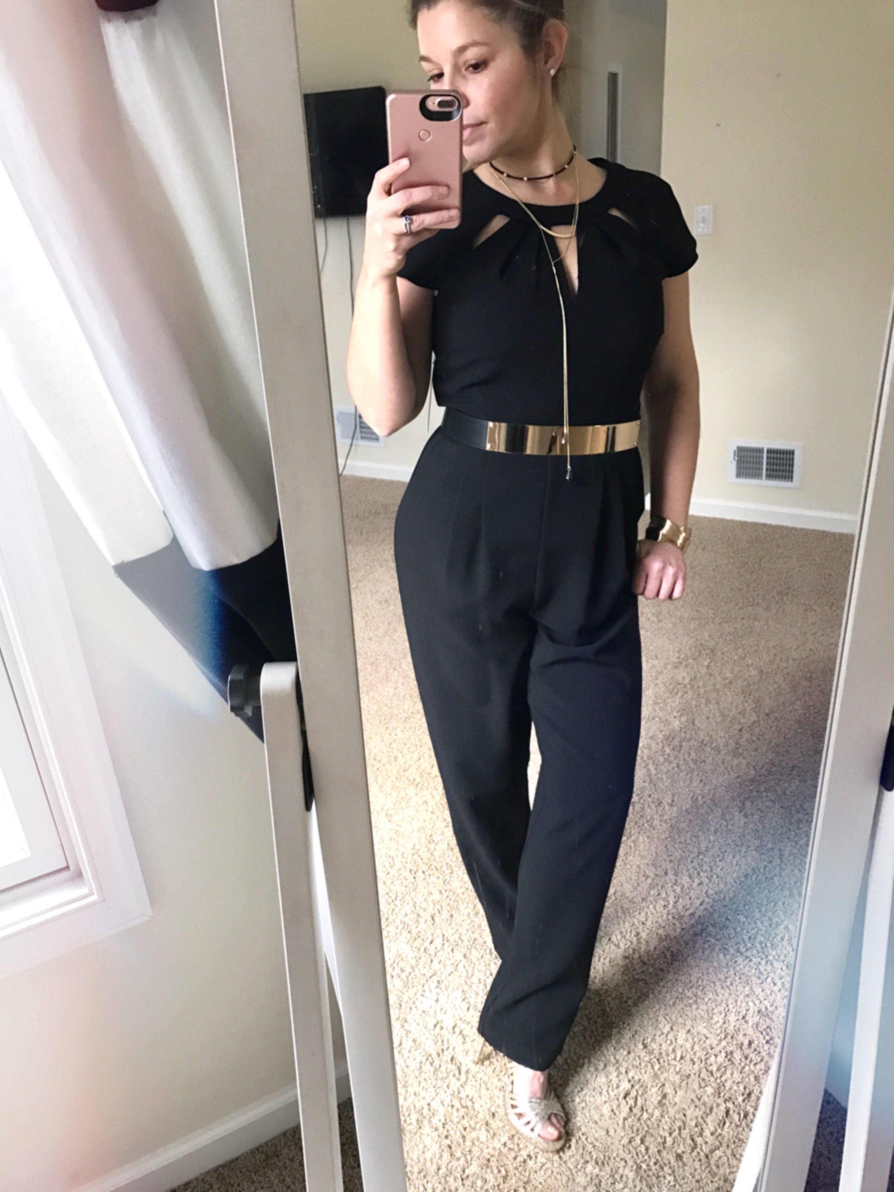 Black jumpsuit with gold belt. A conservative and modest Vegas outfit
