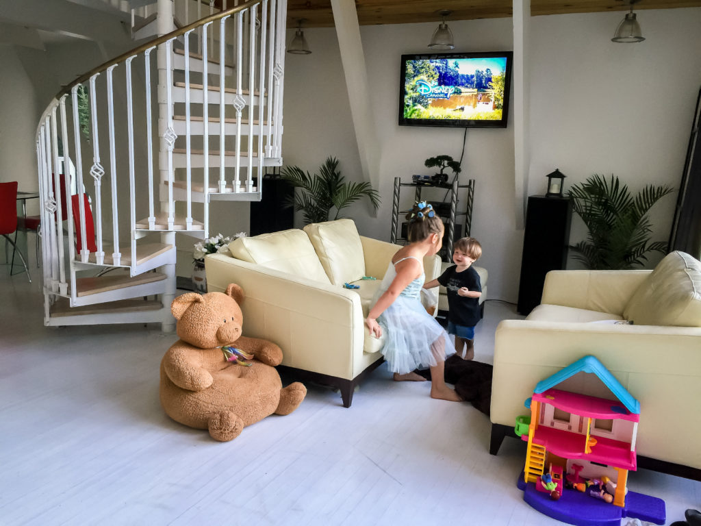 2 kids playing in an Airbnb living room