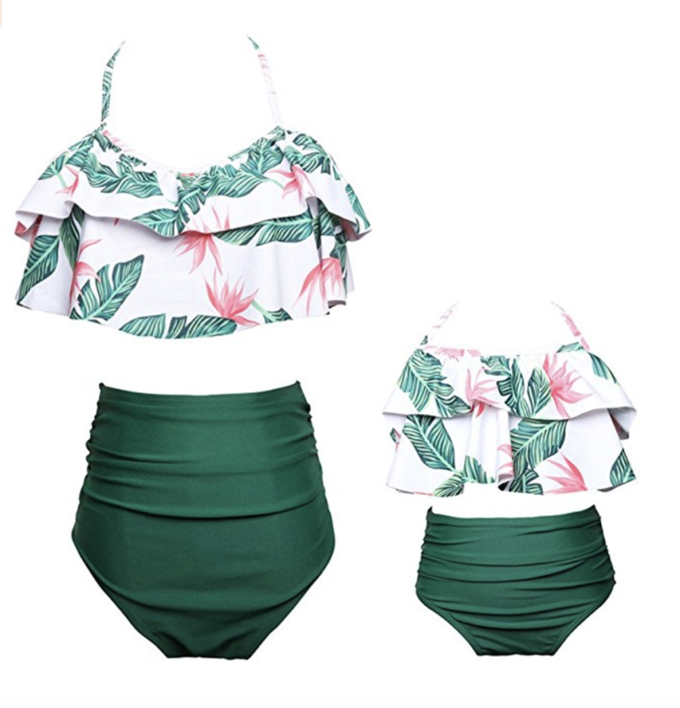 Matching mother-daughter bathing suits 2 pieces, with green leaf print tops and plain green bottoms. 