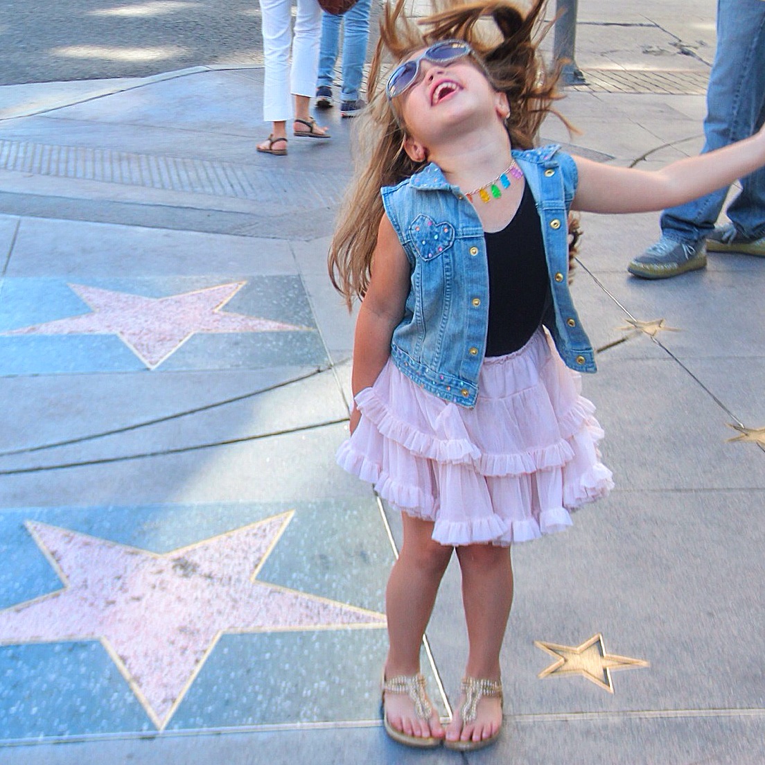 A little girl on the Hollywood walk of fame